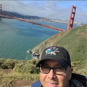 Selfie of David in a baseball cap with the Golden Gate Bridge in the background.