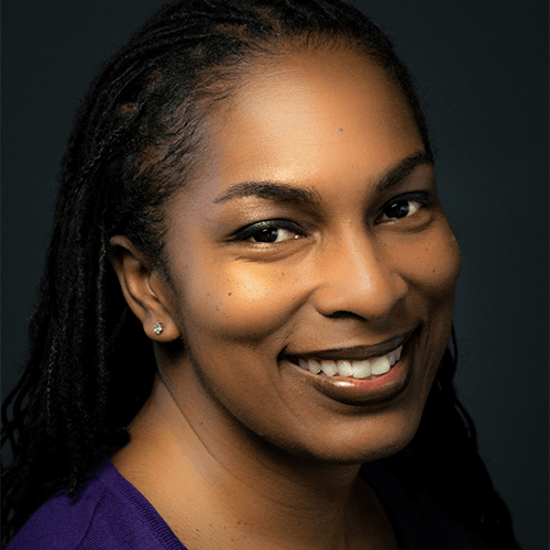 Kimberly Ridgeway, a Black woman with her hair in braids, smiles at the camera